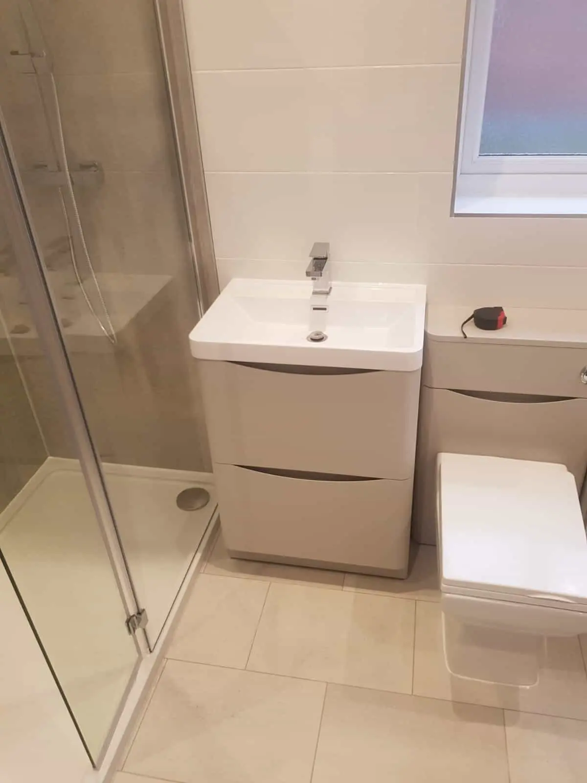 Modern bathroom with a glass shower enclosure, vanity basin and toilet