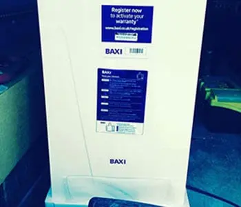 White Baxi boiler with warranty registration labels on the front