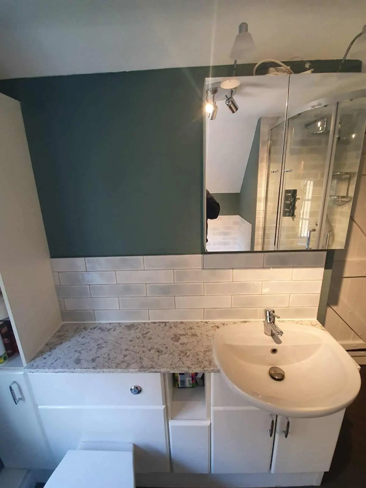 Fitted bathroom vanity with granite worktop, basin and mirrored cabinet