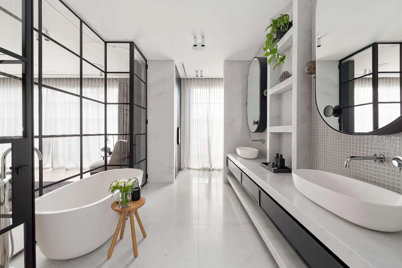Modern bathroom with a freestanding bath, glass shower screen and double-sink vanity