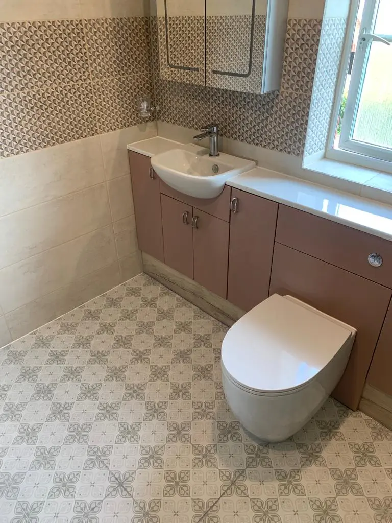 Renovated bathroom with a wall-mounted basin, vanity units and modern toilet